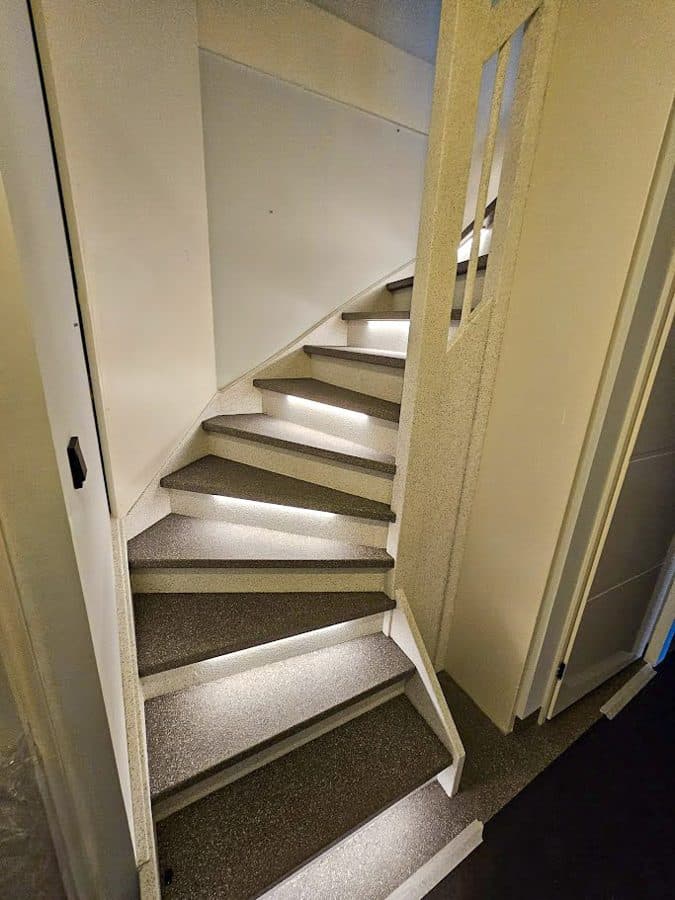 Signature stair renovation — full bespoke, seamless from tread to wall