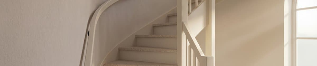 Curved staircase with natural stone composite overlay treads
