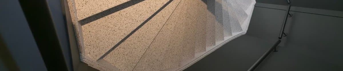 Staircase with natural stone composite overlay treads, view from below