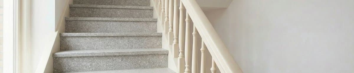 Stairwell with natural stone composite overlay treads